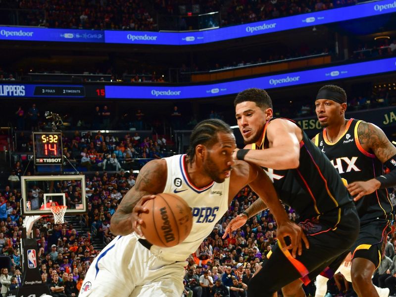 PHOENIX, AZ - APRIL 18:  Devin Booker #1 of the Phoenix Suns plays defense during the game  against Kawhi Leonard #2 of the LA Clippers during round one game two of the 2023 NBA Playoffs on April 18, 2023 at Footprint Center in Phoenix, Arizona. NOTE TO USER: User expressly acknowledges and agrees that, by downloading and or using this photograph, user is consenting to the terms and conditions of the Getty Images License Agreement. Mandatory Copyright Notice: Copyright 2023 NBAE (Photo by Kate Frese/NBAE via Getty Images)