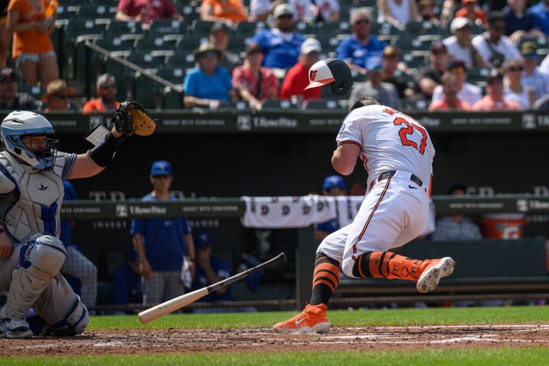 Jul 29, 2024; Baltimore, Maryland, USA; Baltimore Orioles catcher James McCann (27) reacts after being hit in the head with a pitch during the first inning against the Toronto Blue Jays at Oriole Park at Camden Yards. Mandatory Credit: Reggie Hildred-USA TODAY Sports