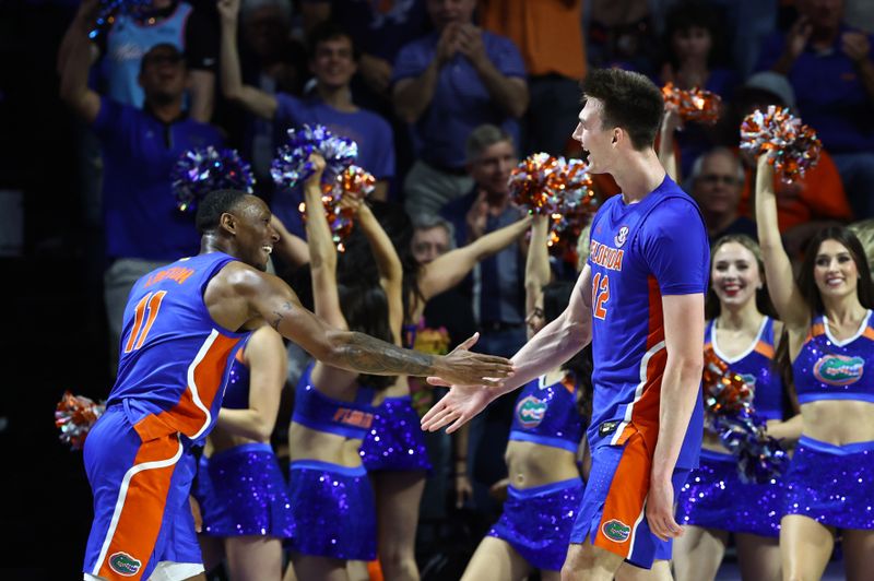 Feb 1, 2023; Gainesville, Florida, USA; Florida Gators forward Colin Castleton (12) celebrates with guard Kyle Lofton (11) after making a basket against the Tennessee Volunteers during the second half at Exactech Arena at the Stephen C. O'Connell Center. Mandatory Credit: Kim Klement-USA TODAY Sports