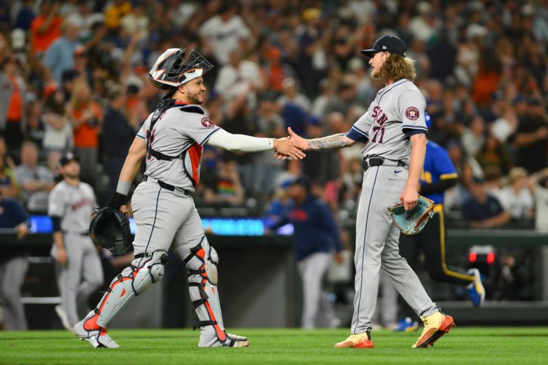 Jul 19, 2024; Seattle, Washington, USA; Houston Astros catcher Yainer Diaz (21) and relief pitcher Josh Hader (71) celebrate defeating the Seattle Mariners at T-Mobile Park. Mandatory Credit: Steven Bisig-USA TODAY Sports