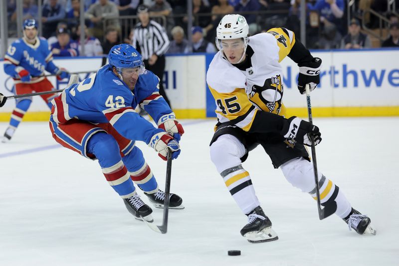 Oct 7, 2025; New York, New York, USA; Pittsburgh Penguins defenseman Harrison Brunicke (45) plays the puck against New York Rangers center Noah Laba (42) during the third period at Madison Square Garden. Mandatory Credit: Brad Penner-Imagn Images