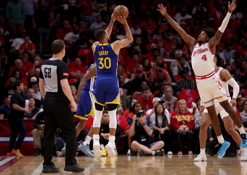 HOUSTON, TEXAS - APRIL 04: Stephen Curry #30 of the Golden State Warriors takes a three-point shot against Jalen Green #4 of the Houston Rockets in the first half at Toyota Center on April 04, 2024 in Houston, Texas.  NOTE TO USER: User expressly acknowledges and agrees that, by downloading and or using this photograph, User is consenting to the terms and conditions of the Getty Images License Agreement. (Photo by Tim Warner/Getty Images)