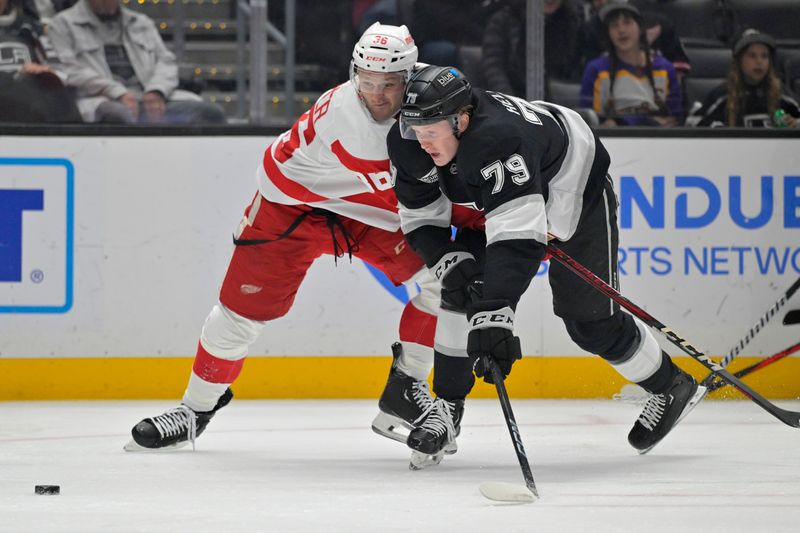 Nov 16, 2024; Los Angeles, California, USA; Detroit Red Wings right wing Christian Fischer (36) and Los Angeles Kings Jacob center Samuel Heleniux (79) go for the puck in the first period at Crypto.com Arena. Mandatory Credit: Jayne Kamin-Oncea-Imagn Images