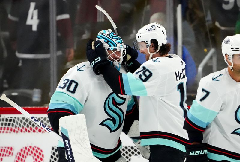 Oct 21, 2022; Denver, Colorado, USA; Seattle Kraken goaltender Martin Jones (30) and center Ryan Donato (9) celebrate defeating the Colorado Avalanche at Ball Arena. Mandatory Credit: Ron Chenoy-USA TODAY Sports