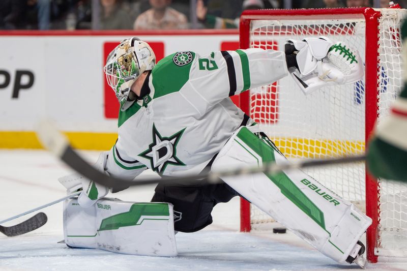 Apr 6, 2025; Saint Paul, Minnesota, USA; A shot by Minnesota Wild center Marco Rossi (23) goes past Dallas Stars goaltender Jake Oettinger (29)in in overtime at Xcel Energy Center. Mandatory Credit: Matt Blewett-Imagn Images