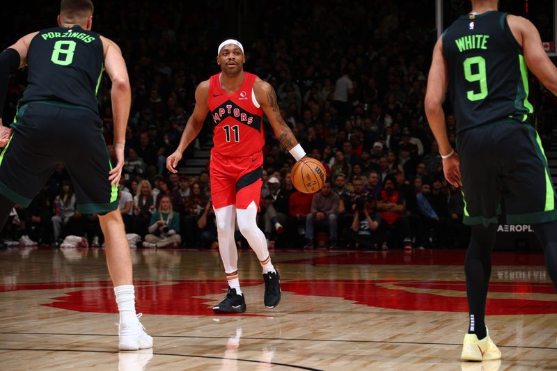 TORONTO, CANADA - JANUARY 15: Bruce Brown #11 of the Toronto Raptors dribbles the ball during the game against the Boston Celtics on January 15, 2025 at the Scotiabank Arena in Toronto, Ontario, Canada.  NOTE TO USER: User expressly acknowledges and agrees that, by downloading and or using this Photograph, user is consenting to the terms and conditions of the Getty Images License Agreement.  Mandatory Copyright Notice: Copyright 2025 NBAE (Photo by Vaughn Ridley/NBAE via Getty Images)