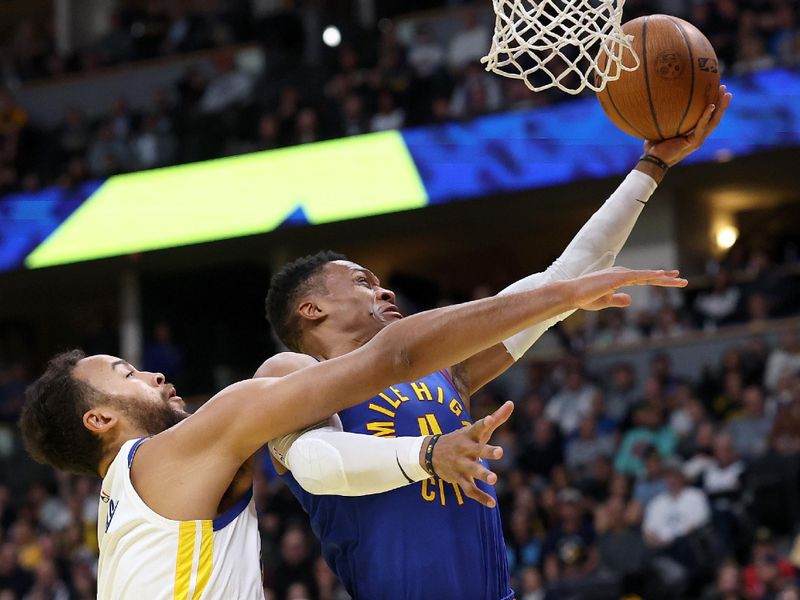 DENVER, COLORADO - DECEMBER 03: JRussell Westborrk #4 of the Denver Nuggets goes to the basket against Kyle Anderson #1 of the Golden State Warriors in the first quarter of the Emirates NBA Cup at Ball Arena on December 3, 2024 in Denver, Colorado. NOTE TO USER: User expressly acknowledges and agrees that, by downloading and or using this photograph, User is consenting to the terms and conditions of the Getty Images License Agreement.  (Photo by Matthew Stockman/Getty Images)