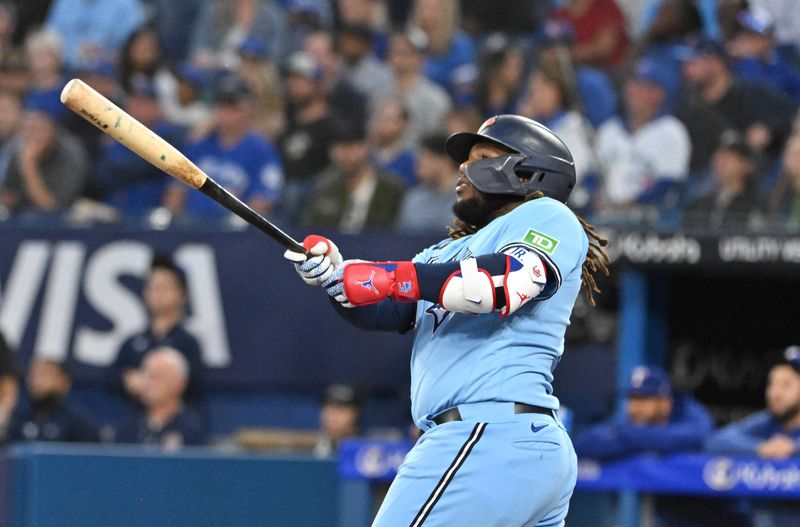 Sep 14, 2023; Toronto, Ontario, CAN;   Toronto Blue Jays first baseman Vladimir Guerrero Jr. (27) hits a two run home run against the Texas Rangers in the first inning at Rogers Centre. Mandatory Credit: Dan Hamilton-USA TODAY Sports