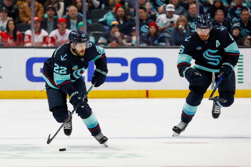 Feb 19, 2024; Seattle, Washington, USA; Seattle Kraken right wing Oliver Bjorkstrand (22) skates with the puck ahead of defenseman Adam Larsson (6) during the second period at Climate Pledge Arena. Mandatory Credit: Joe Nicholson-USA TODAY Sports