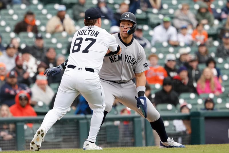 Apr 9, 2025; Detroit, Michigan, USA;  Detroit Tigers pitcher Tyler Holton (87) tags out New York Yankees outfielder Aaron Judge (99) in the sixth inning at Comerica Park. Mandatory Credit: Rick Osentoski-Imagn Images