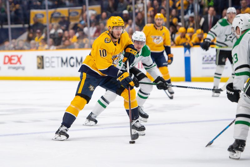 Feb 15, 2024; Nashville, Tennessee, USA; Nashville Predators center Colton Sissons (10) skates with the puck  against the Dallas Stars during the first period at Bridgestone Arena. Mandatory Credit: Steve Roberts-USA TODAY Sports