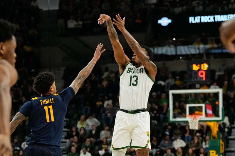 Feb 15, 2025; Waco, Texas, USA; Baylor Bears guard Langston Love (13) scores a three-point basket against West Virginia Mountaineers guard Jonathan Powell (11) during the first half at Paul and Alejandra Foster Pavilion. Mandatory Credit: Chris Jones-Imagn Images