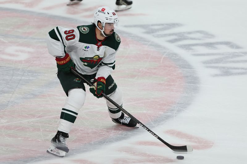Oct 22, 2024; Sunrise, Florida, USA; Minnesota Wild center Marcus Johansson (90) moves the puck against the Florida Panthers during the third period at Amerant Bank Arena. Mandatory Credit: Sam Navarro-Imagn Images