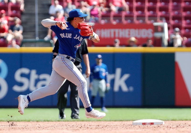 Aug 20, 2023; Cincinnati, Ohio, USA; Toronto Blue Jays second baseman Whit Merrifield (15) throws to first for the out against the Cincinnati Reds during the ninth inning at Great American Ball Park. Mandatory Credit: David Kohl-USA TODAY Sports