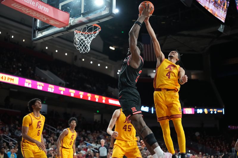 Jan 31, 2026; Los Angeles, California, USA; Rutgers Scarlet Knights center Emmanuel Ogbole (21) attempts to dunk the ball against Southern California Trojans guard Chad Baker-Mazara (4) in the first half at Galen Center. Mandatory Credit: Kirby Lee-Imagn Images