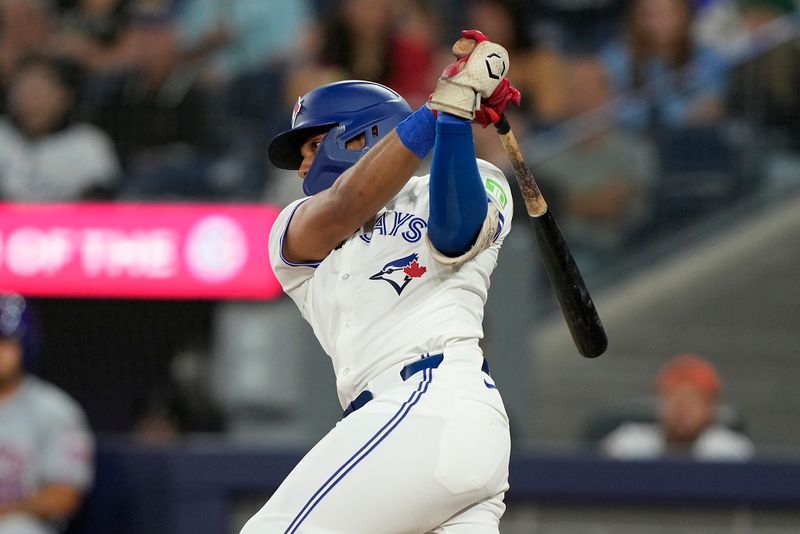 Sep 10, 2024; Toronto, Ontario, CAN; Toronto Blue Jays shortstop Leo Jimenez (49) hits a one run single against the New York Mets during the second inning at Rogers Centre. Mandatory Credit: John E. Sokolowski-Imagn Images