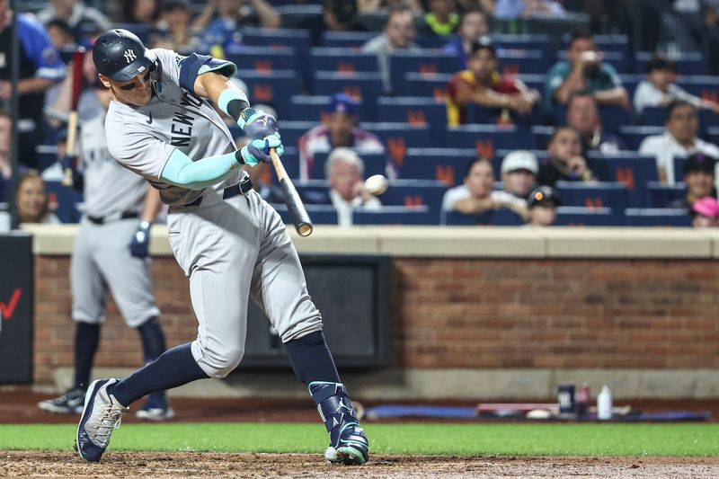 Jun 26, 2024; New York City, New York, USA;  New York Yankees center fielder Aaron Judge (99) hits a two run home run in the sixth inning against the New York Mets at Citi Field. Mandatory Credit: Wendell Cruz-USA TODAY Sports