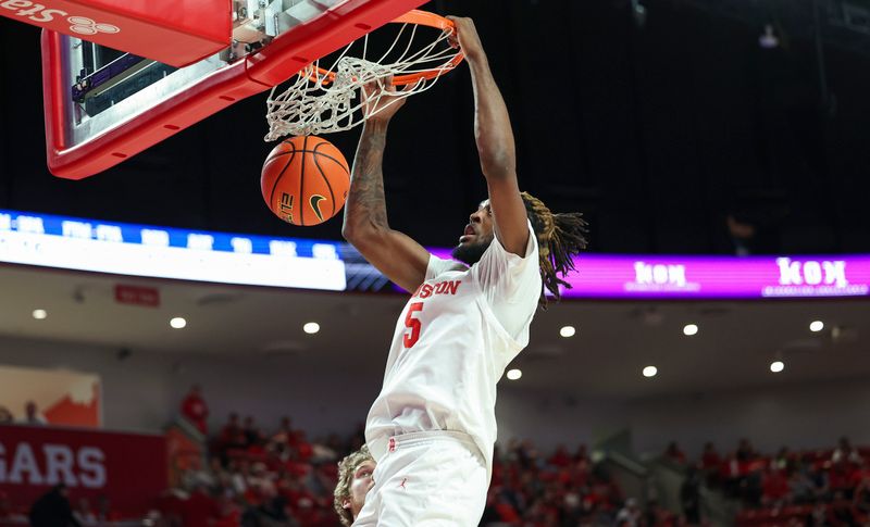 Dec 6, 2023; Houston, Texas, USA; Houston Cougars forward Ja'Vier Francis (5) dunks the ball during the second half against the Rice Owls at Fertitta Center. Mandatory Credit: Troy Taormina-USA TODAY Sports