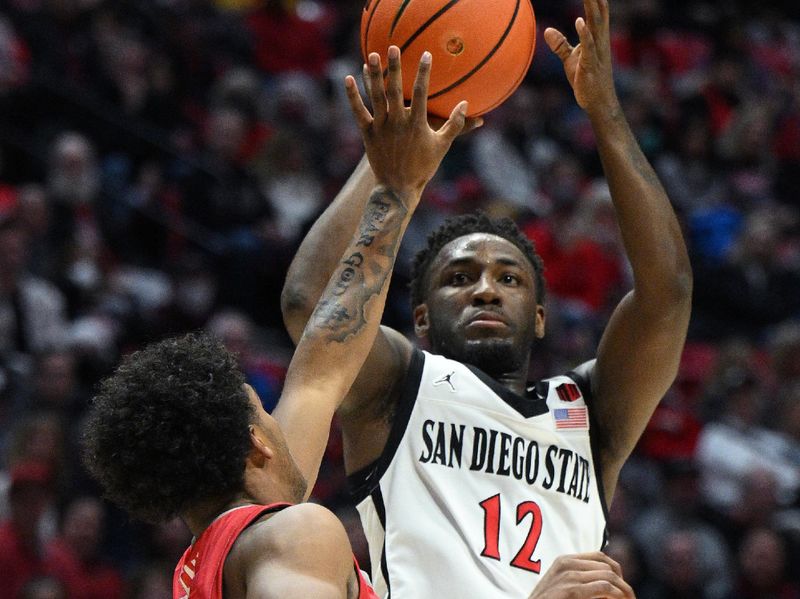 Jan 14, 2023; San Diego, California, USA; San Diego State Aztecs guard Darrion Trammell (12) shoots the ball over New Mexico Lobos guard Donovan Dent (2) during the first half at Viejas Arena. Mandatory Credit: Orlando Ramirez-USA TODAY Sports