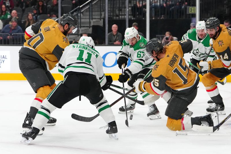 Dec 6, 2024; Las Vegas, Nevada, USA; Vegas Golden Knights center Nicolas Roy (10) and Dallas Stars center Logan Stankoven (11), and right wing Evgenii Dadonov (63) and Vegas Golden Knights defenseman Noah Hanifin (15) battle for control of the puck during the first period at T-Mobile Arena. Mandatory Credit: Stephen R. Sylvanie-Imagn Images