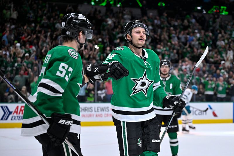 Oct 15, 2024; Dallas, Texas, USA; Dallas Stars center Wyatt Johnston (53) and center Roope Hintz (24) celebrates a goal scored by Hintz against the San Jose Sharks during the second period at the American Airlines Center. Mandatory Credit: Jerome Miron-Imagn Images