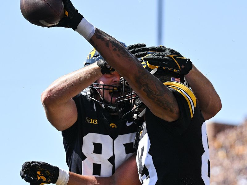 Sep 2, 2023; Iowa City, Iowa, USA; Iowa Hawkeyes tight end Erick All (83) reacts with tight end Steven Stilianos (86) after scoring a touchdown during the first quarter against the Utah State Aggies at Kinnick Stadium. Mandatory Credit: Jeffrey Becker-USA TODAY Sports