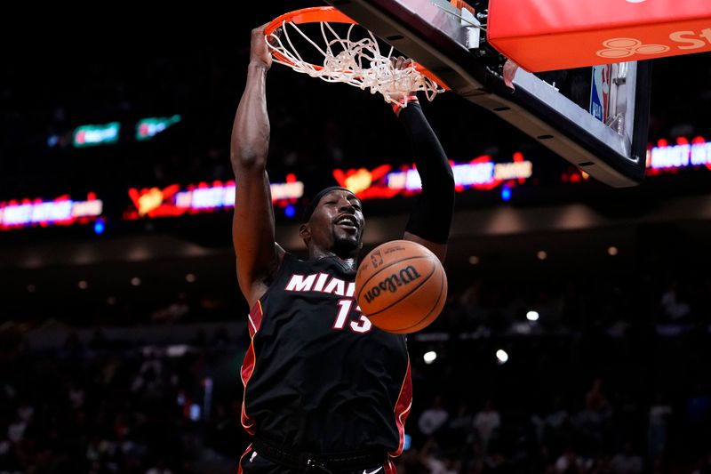 MIAMI, FLORIDA - MARCH 24: Bam Adebayo #13 of the Miami Heat dunks the ball against the Cleveland Cavaliers during the third quarter at Kaseya Center on March 24, 2024 in Miami, Florida. NOTE TO USER: User expressly acknowledges and agrees that, by downloading and or using this photograph, User is consenting to the terms and conditions of the Getty Images License Agreement. (Photo by Rich Storry/Getty Images)