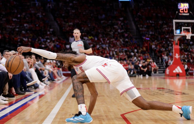 HOUSTON, TEXAS - APRIL 04: Jalen Green #4 of the Houston Rockets attempts to save a ball along the sideline in the second half against the Golden State Warriors at Toyota Center on April 04, 2024 in Houston, Texas.  NOTE TO USER: User expressly acknowledges and agrees that, by downloading and or using this photograph, User is consenting to the terms and conditions of the Getty Images License Agreement. (Photo by Tim Warner/Getty Images)