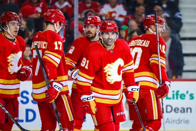 Feb 19, 2024; Calgary, Alberta, CAN; Calgary Flames center Nazem Kadri (91) celebrates his goal with teammates against the Winnipeg Jets during the second period at Scotiabank Saddledome. Mandatory Credit: Sergei Belski-USA TODAY Sports