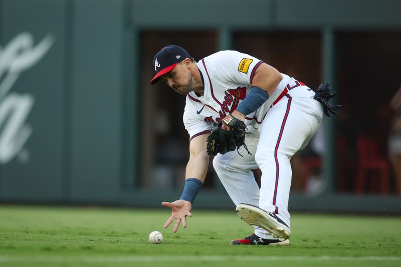 May 30, 2024; Atlanta, Georgia, USA; Atlanta Braves right fielder Adam Duvall (14) fields a ball against the Washington Nationals in the first inning at Truist Park. Mandatory Credit: Brett Davis-USA TODAY Sports
