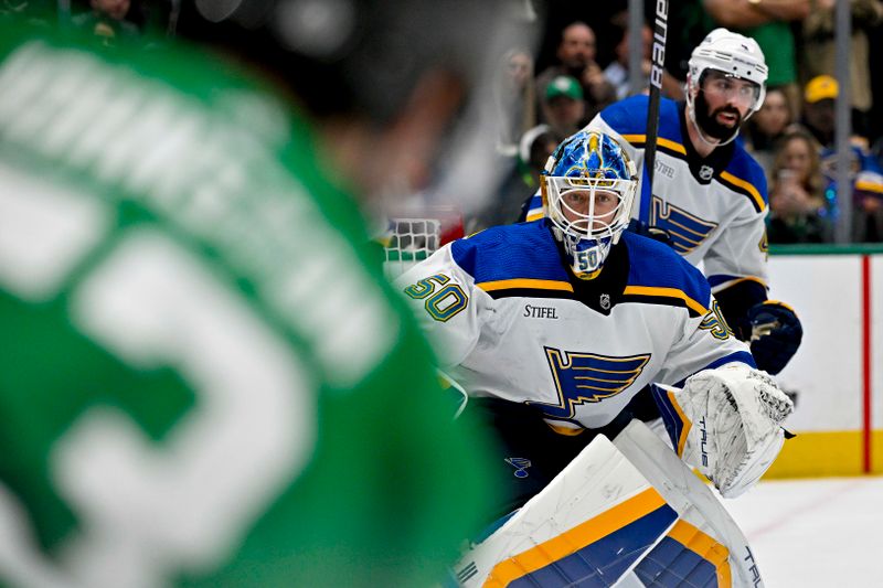 Apr 17, 2024; Dallas, Texas, USA; St. Louis Blues goaltender Jordan Binnington (50) faces a shot by Dallas Stars center Wyatt Johnston (53) during the overtime period at the American Airlines Center. Mandatory Credit: Jerome Miron-USA TODAY Sports