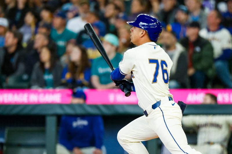 Apr 28, 2024; Seattle, Washington, USA; Seattle Mariners shortstop Leo Rivas (76) hits a triple against the Arizona Diamondbacks during the third inning at T-Mobile Park. The play was the first major league hit for Rivas. Mandatory Credit: Joe Nicholson-USA TODAY Sports