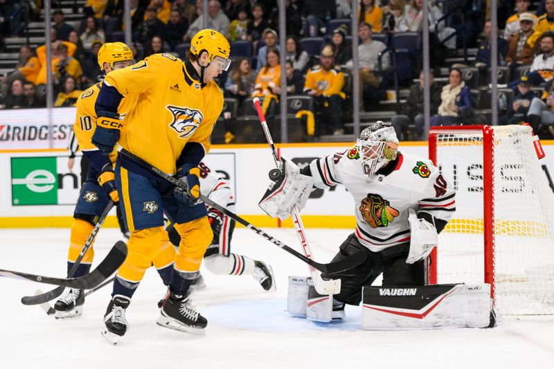 Jan 16, 2025; Nashville, Tennessee, USA;  Chicago Blackhawks goaltender Arvid Soderblom (40) blocks the shot of Nashville Predators right wing Michael McCarron (47) during the third period at Bridgestone Arena. Mandatory Credit: Steve Roberts-Imagn Images