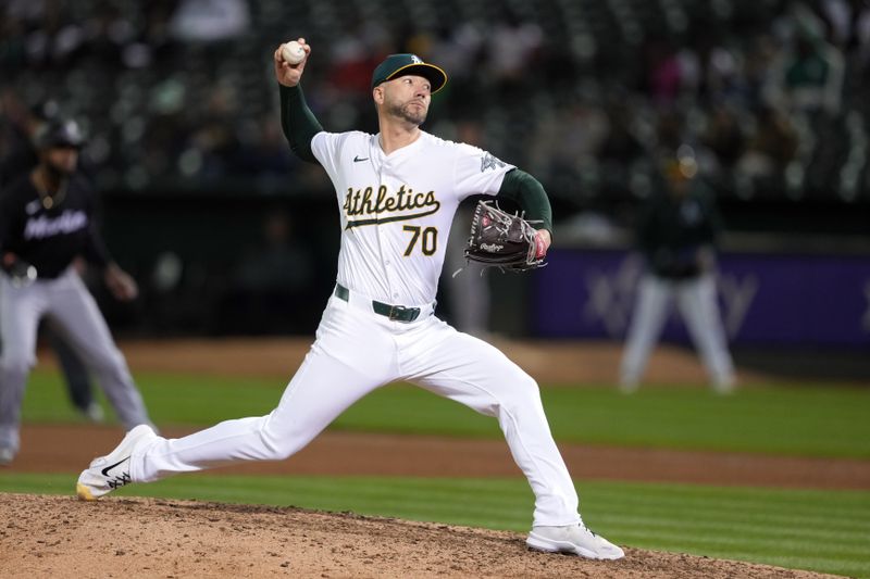 May 3, 2024; Oakland, California, USA; Oakland Athletics relief pitcher Lucas Erceg (70) throws a pitch against the Miami Marlins during the eighth inning at Oakland-Alameda County Coliseum. Mandatory Credit: Darren Yamashita-USA TODAY Sports