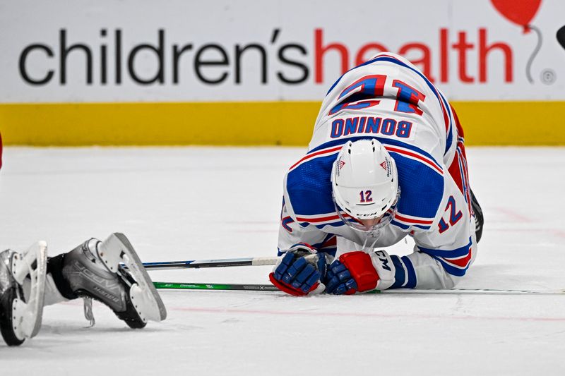 Nov 20, 2023; Dallas, Texas, USA; New York Rangers center Nick Bonino (12) falls to the ice during the third period against the Dallas Stars at the American Airlines Center. Mandatory Credit: Jerome Miron-USA TODAY Sports