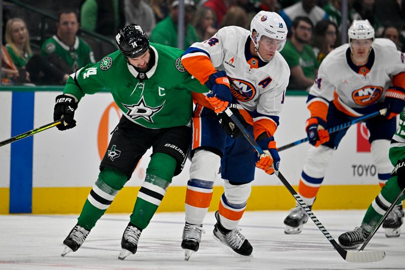 Oct 12, 2024; Dallas, Texas, USA; Dallas Stars left wing Jamie Benn (14) and New York Islanders center Bo Horvat (14) battle for control of the puck during the third period at the American Airlines Center. Mandatory Credit: Jerome Miron-Imagn Images