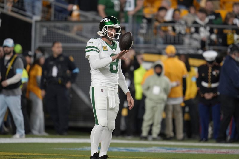 New York Jets quarterback Aaron Rodgers (8) warms up before an NFL football game against the Pittsburgh Steelers in Pittsburgh, Sunday, Oct. 20, 2024. (AP Photo/Gene J. Puskar)