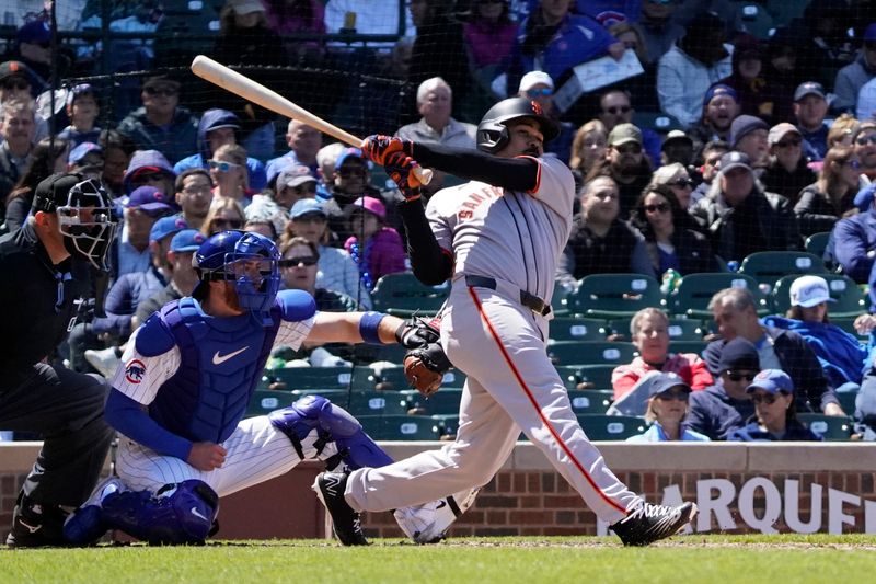May 7, 2025; Chicago, Illinois, USA; San Francisco Giants first base LaMonte Wade Jr. (31) hits a one run double against the Chicago Cubs during the fourth inning at Wrigley Field. Mandatory Credit: David Banks-Imagn Images