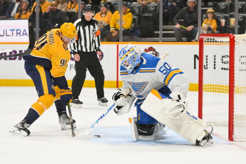 Dec 11, 2025; Nashville, Tennessee, USA;  St. Louis Blues goaltender Jordan Binnington (50) blocks the shot of Nashville Predators center Steven Stamkos (91) during the first period at Bridgestone Arena. Mandatory Credit: Steve Roberts-Imagn Images