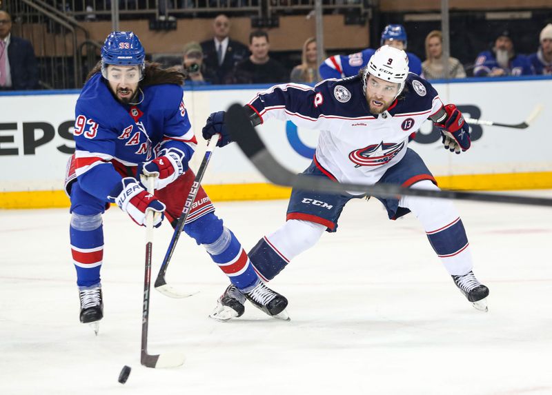 Jan 18, 2025; New York, New York, USA; Columbus Blue Jackets defenseman Ivan Provorov (9) swats at New York Rangers center Mika Zibanejad (93) during the first period at Madison Square Garden. Mandatory Credit: Danny Wild-Imagn Images