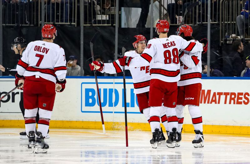 Jan 2, 2024; New York, New York, USA; Carolina Hurricanes defenseman Jalen Chatfield (5) celebrates his goal with center Martin Necas (88) during the third period against the New York Rangers at Madison Square Garden. Mandatory Credit: Danny Wild-USA TODAY Sports