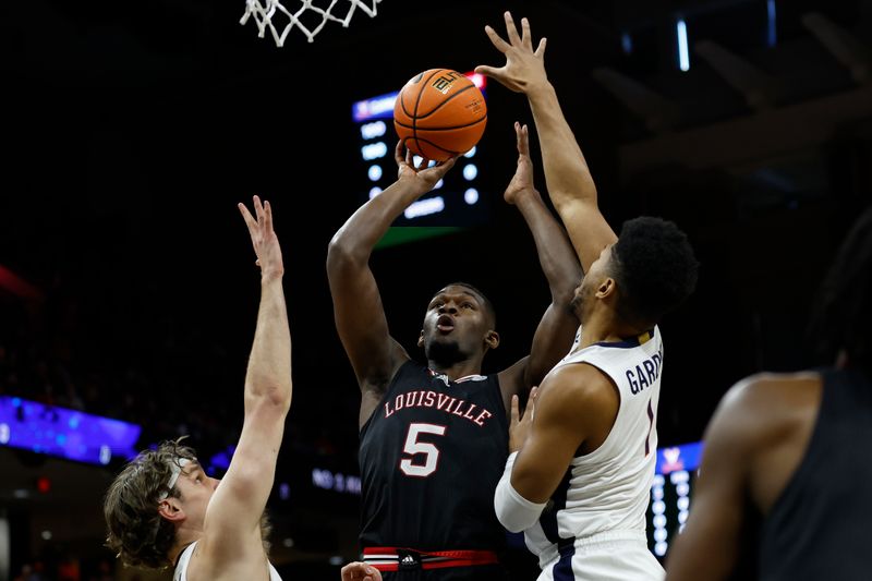 Mar 4, 2023; Charlottesville, Virginia, USA; Louisville Cardinals forward Brandon Huntley-Hatfield (5) shoots the ball as Virginia Cavaliers forward Ben Vander Plas (5) and Cavaliers forward Jayden Gardner (1) defend in the first half at John Paul Jones Arena. Mandatory Credit: Geoff Burke-USA TODAY Sports