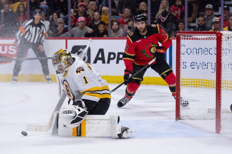 Oct 27, 2025; Ottawa, Ontario, CAN; Boston Bruins goalie Jeremy Swayman (1) makes a save as Ottawa Senators right wing Michael Amadio (22) looks on in the first period at the Canadian Tire Centre. Mandatory Credit: Marc DesRosiers-IMAGN Images