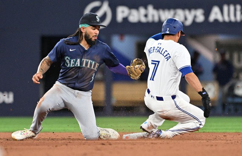 Apr 8, 2024; Toronto, Ontario, CAN;  Toronto Blue Jays third baseman Isiah Kiner-Falefa (7) steals second base ahead of a tag from Seattle Mariners shortstop J.P. Crawford (3) in the eighth inning at Rogers Centre. Mandatory Credit: Dan Hamilton-USA TODAY Sports