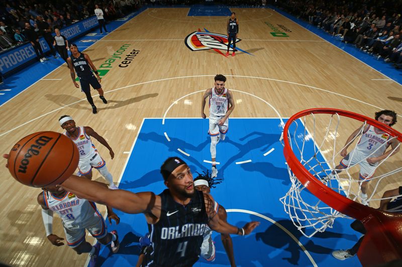 OKLAHOMA CITY, OK - JANUARY 13: Jalen Suggs #4 of the Orlando Magic dunks the ball during the game against the Oklahoma City Thunder on January 13, 2024 at Paycom Arena in Oklahoma City, Oklahoma. NOTE TO USER: User expressly acknowledges and agrees that, by downloading and or using this photograph, User is consenting to the terms and conditions of the Getty Images License Agreement. Mandatory Copyright Notice: Copyright 2024 NBAE (Photo by Zach Beeker/NBAE via Getty Images)