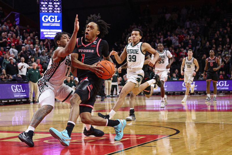 Jan 27, 2026; Piscataway, New Jersey, USA; Rutgers Scarlet Knights guard Jamichael Davis (1) goes to the basket against Michigan State Spartans guard Jeremy Fears Jr. (1) during the second half at Jersey Mike's Arena. Mandatory Credit: Vincent Carchietta-Imagn Images