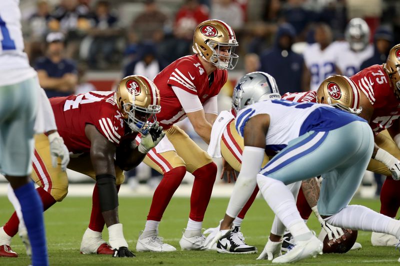 San Francisco 49ers quarterback Sam Darnold (14) calls a play during an NFL football game against the Dallas Cowboys, Sunday, Oct 8, 2023, in Santa Clara, Calif. (AP Photo/Scot Tucker)