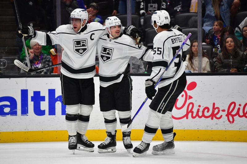 Nov 24, 2023; Anaheim, California, USA; Los Angeles Kings left wing Kevin Fiala (22) celebrates his goal scored against the Anaheim Ducks with center Anze Kopitar (11) and center Quinton Byfield (55) during the first period at Honda Center. Mandatory Credit: Gary A. Vasquez-USA TODAY Sports