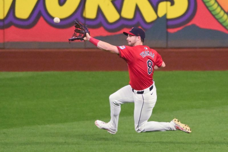 Sep 12, 2024; Cleveland, Ohio, USA; Cleveland Guardians right fielder Lane Thomas (8) makes a sliding catch in the third inning against the Tampa Bay Rays at Progressive Field. Mandatory Credit: David Richard-Imagn Images