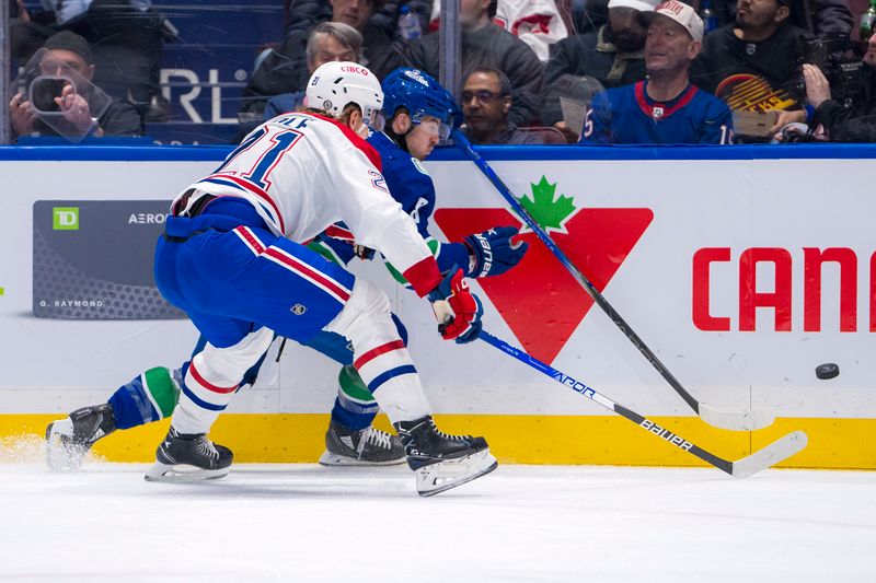 Mar 21, 2024; Vancouver, British Columbia, CAN; Montreal Canadiens defenseman Kaiden Guhle (21) checks Vancouver Canucks forward Conor Garland (8) in the first period at Rogers Arena. Mandatory Credit: Bob Frid-USA TODAY Sports